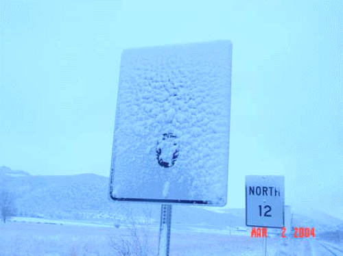 Experimental study on installing tilted signs to prevent snow accretion on sign surfaces