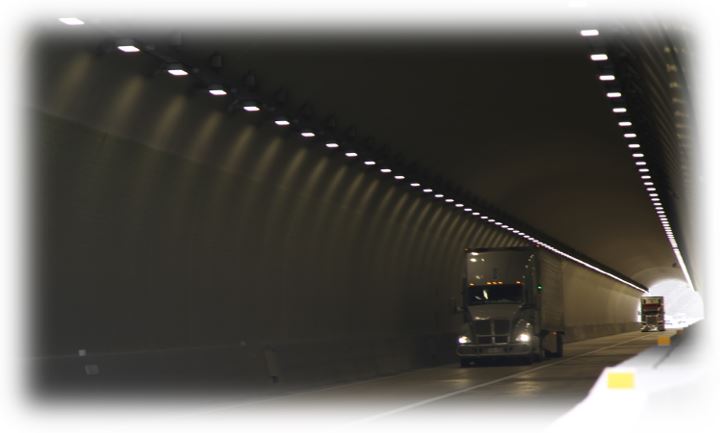 A photo of a truck driving through a tunnel