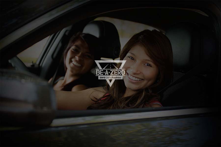 A photo of a smiling female driver and her passenger