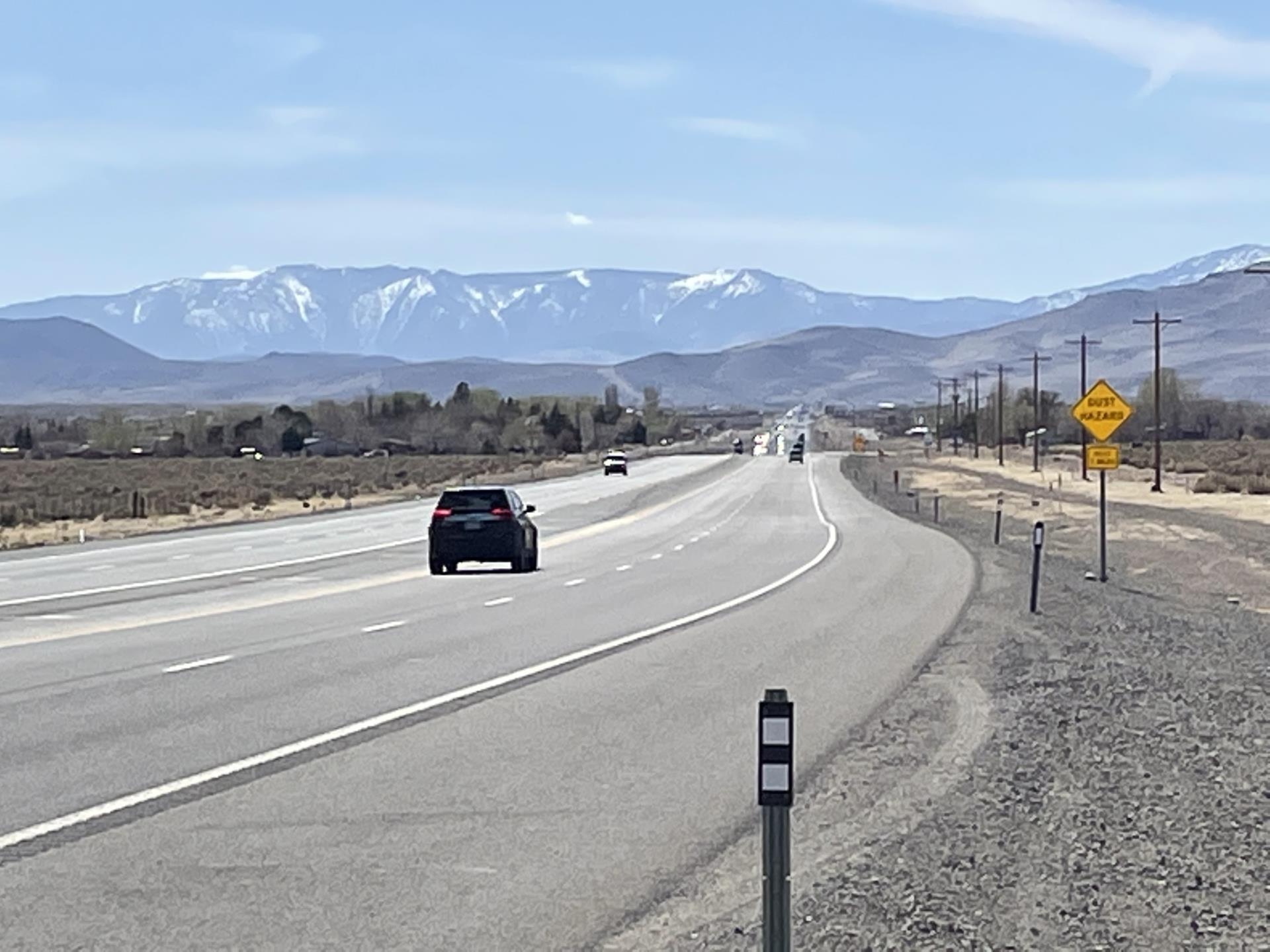 Car on a long road near mountain