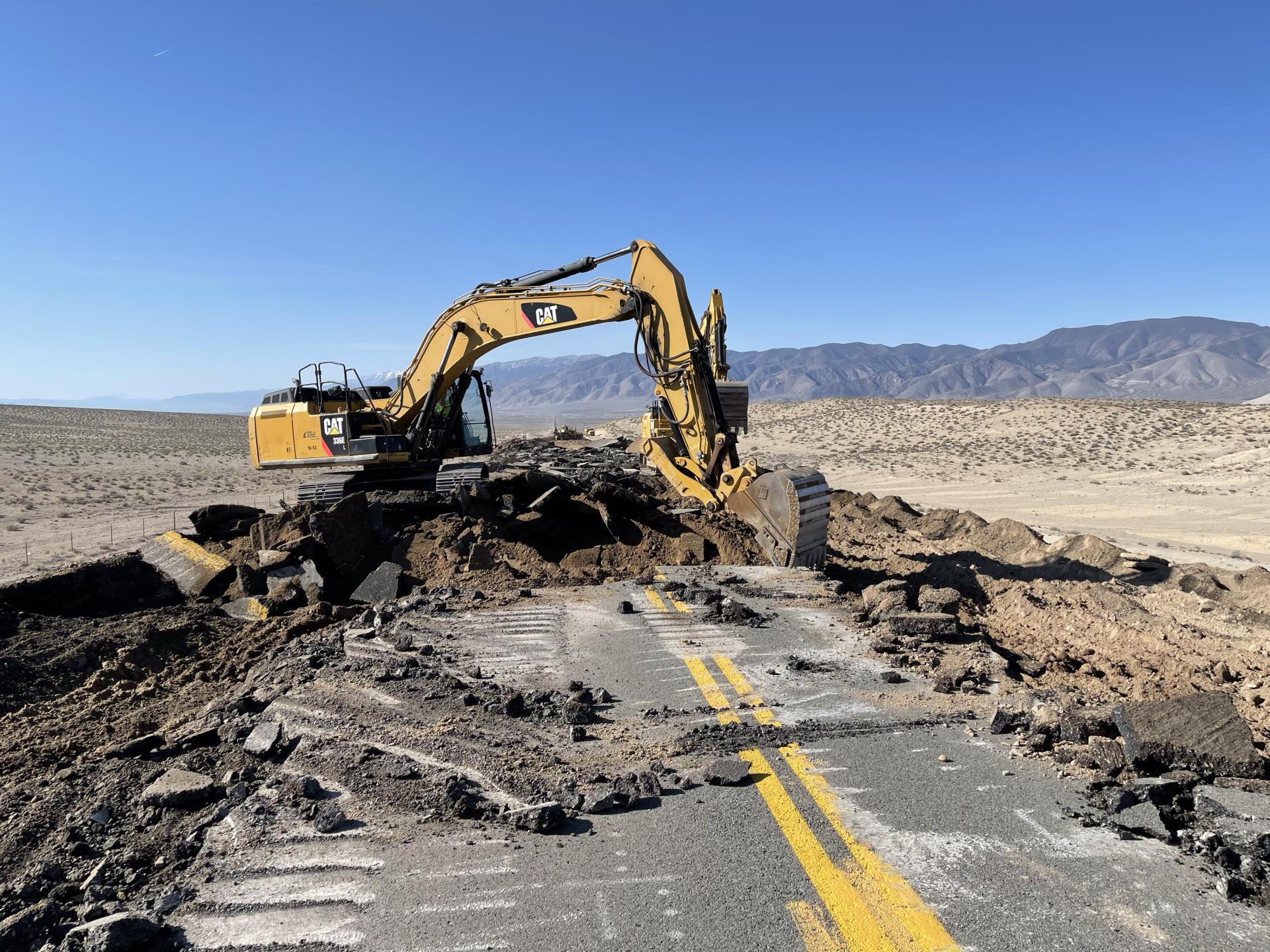 Construction equipment digging up a road