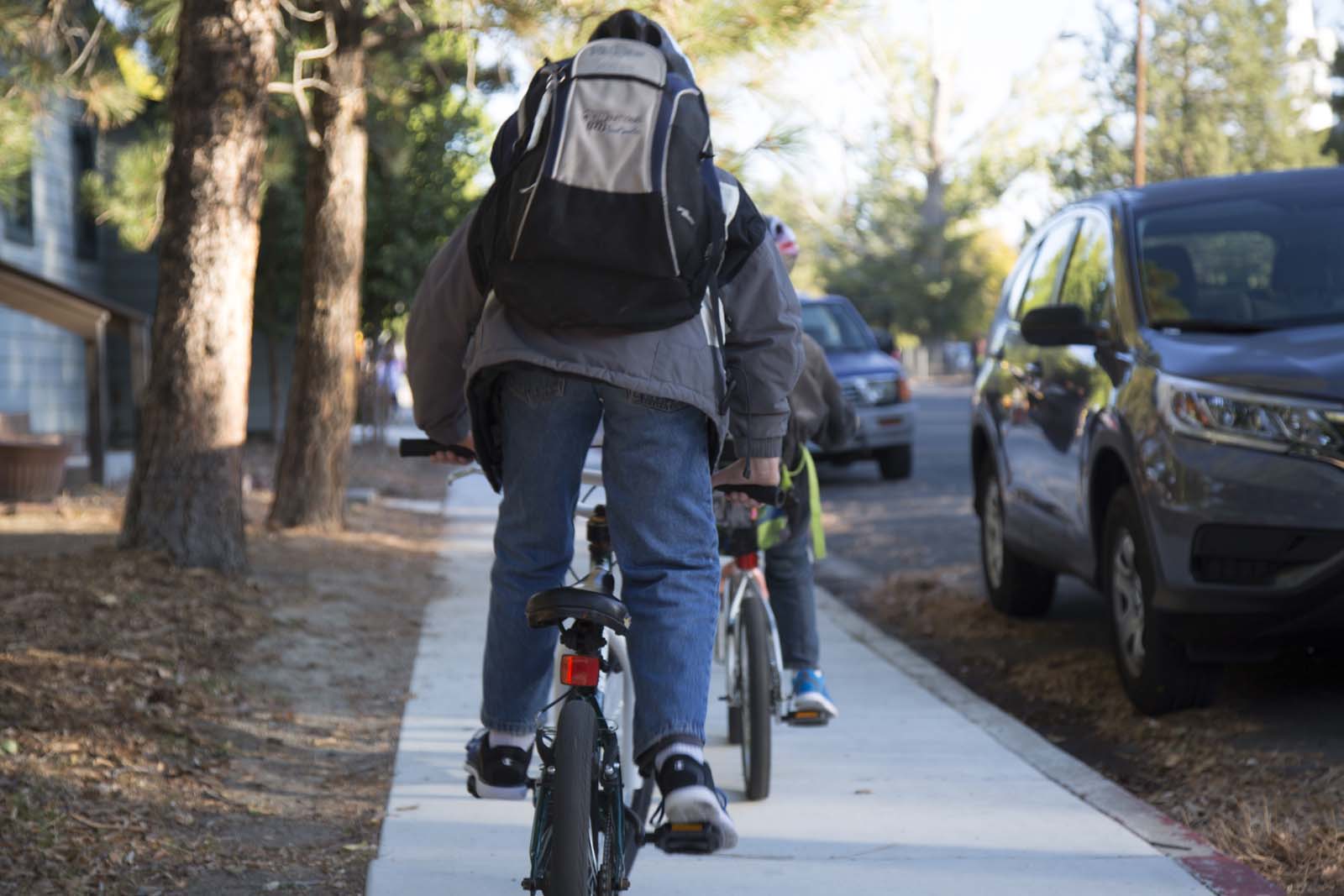 Child on a bike wearing a backpack